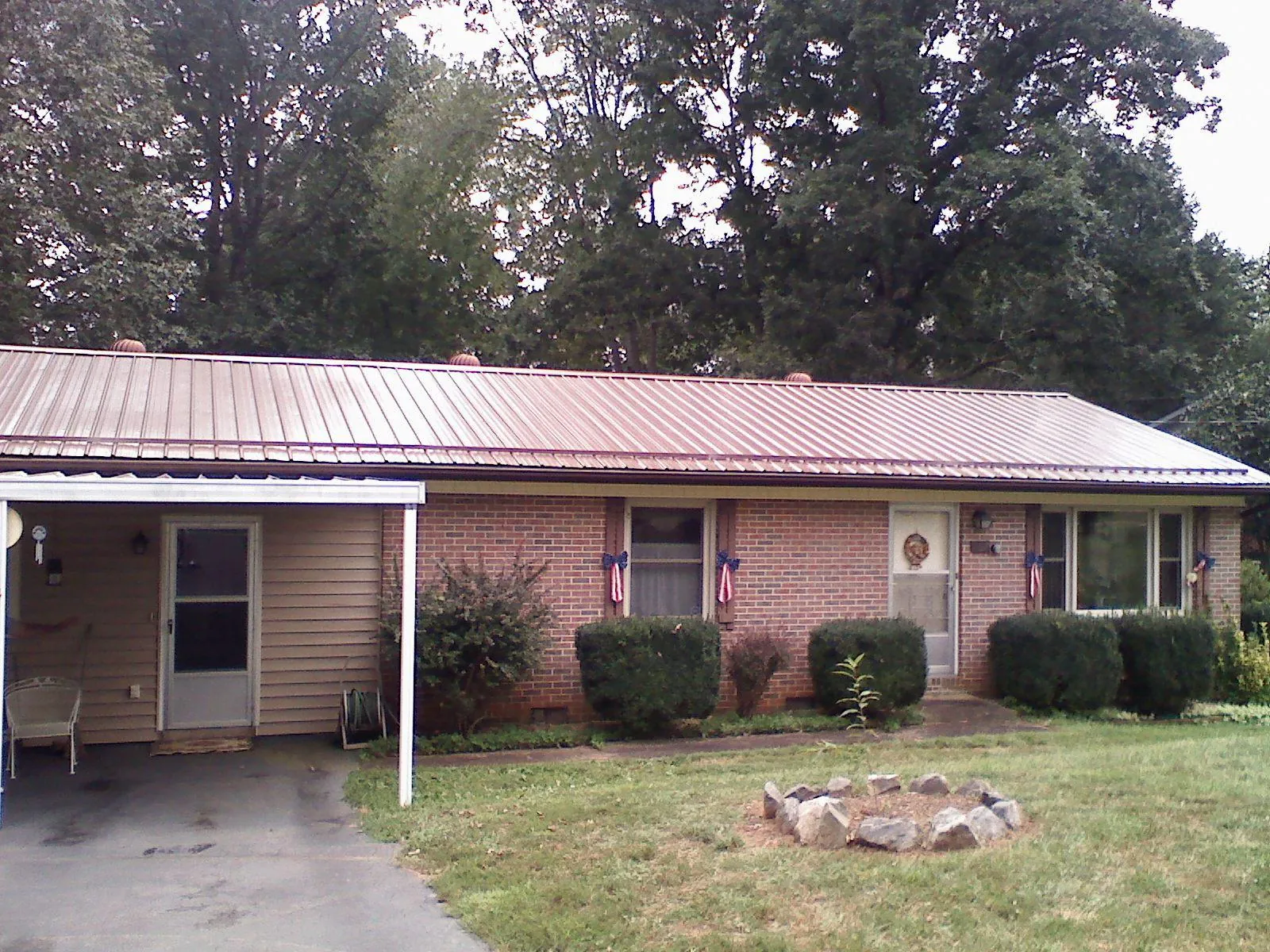 Bronze metal roof and carport on a brick ranch home — Roof Repair work by our crew in White Marsh