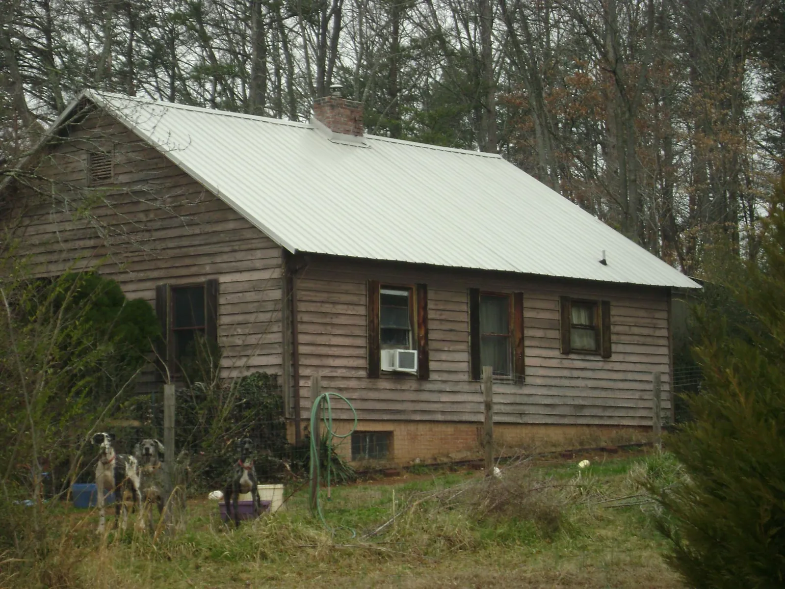 White metal roof on an old wood sided farmhouse, from a Metal Roof Installation job in White Marsh